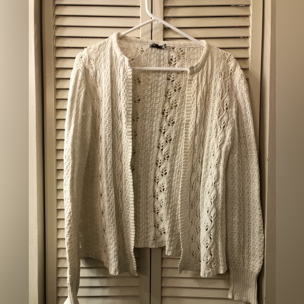 Woman’s White crocheted sweater.